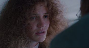 Movie still from “Being John Malkovich” (1999), directed by Spike Jonze – A person with curly hair; Close Up shot, Over the shoulder angle