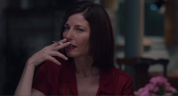 Movie still from “Being John Malkovich” (1999), directed by Spike Jonze – A woman smoking a cigarette while sitting at a table; Close Up shot, Over the shoulder angle