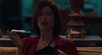 Movie still from “Being John Malkovich” (1999), directed by Spike Jonze – A person sitting in a room; Close Up shot, Over the shoulder angle