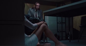 Movie still from “Being John Malkovich” (1999), directed by Spike Jonze – A man and a woman sitting in a room; Medium shot, Low angle