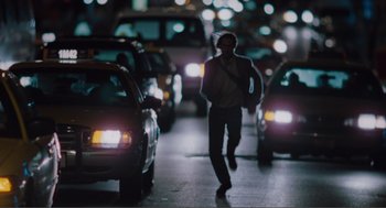 Movie still from “Being John Malkovich” (1999), directed by Spike Jonze – A man walking down the street at night; Wide shot, Over the shoulder angle