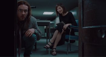 Movie still from “Being John Malkovich” (1999), directed by Spike Jonze – A man and a woman sitting in a room; Medium shot, Low angle