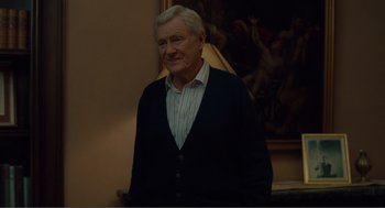 Movie still from “Being John Malkovich” (1999), directed by Spike Jonze – An older man standing in front of a painting; Medium shot, Over the shoulder angle