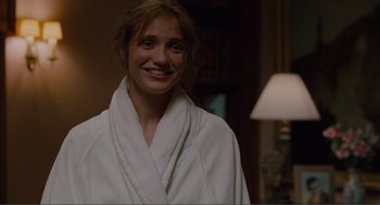 Movie still from “Being John Malkovich” (1999), directed by Spike Jonze – A woman in a white robe smiling for the camera; Close Up shot, Over the shoulder angle