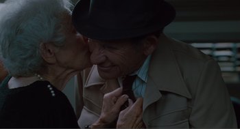 Movie still from “Being John Malkovich” (1999), directed by Spike Jonze – An older man wearing a hat and a tie; Close Up shot, High angle