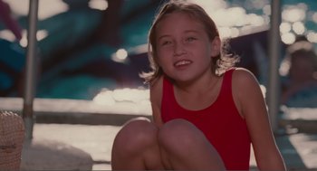 Movie still from “Being John Malkovich” (1999), directed by Spike Jonze – A girl in a red tank top sitting on steps; Close Up shot, High angle