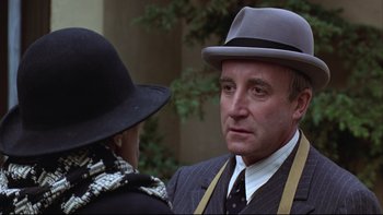 Movie still from “Being There” (1979), directed by Hal Ashby – A man and a woman wearing hats and suits talking to each other; Close Up shot, Over the shoulder angle