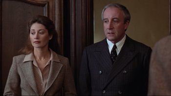 Movie still from “Being There” (1979), directed by Hal Ashby – A man and a woman standing next to each other; Medium shot, Low angle