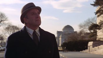 Movie still from “Being There” (1979), directed by Hal Ashby – A man wearing a hat and a coat; Medium shot, Low angle