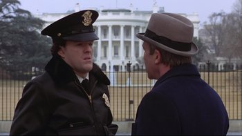 Movie still from “Being There” (1979), directed by Hal Ashby – Two men talking in front of the white house; Medium shot, Low angle