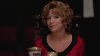 Movie still from “Being There” (1979), directed by Hal Ashby – A person sitting at a table with a glass of water; Close Up shot, Low angle