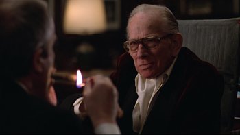 Movie still from “Being There” (1979), directed by Hal Ashby – An older man lighting a cigarette in a dark room; Close Up shot, Over the shoulder angle