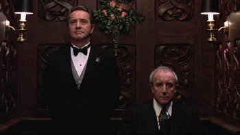 Movie still from “Being There” (1979), directed by Hal Ashby – Two men in tuxedos standing next to each other; Medium shot, Low angle