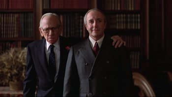 Movie still from “Being There” (1979), directed by Hal Ashby – Two older men in suits posing for a picture; Medium shot, Low angle