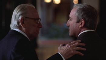 Movie still from “Being There” (1979), directed by Hal Ashby – Two older men in suits talking to each other; Close Up shot, Over the shoulder angle