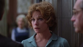 Movie still from “Being There” (1979), directed by Hal Ashby – A person with curly hair; Close Up shot, Over the shoulder angle
