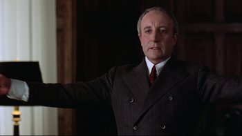 Movie still from “Being There” (1979), directed by Hal Ashby – An older man wearing a suit and tie; Medium shot, Low angle