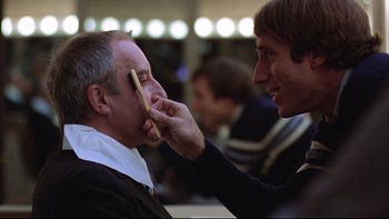 Movie still from “Being There” (1979), directed by Hal Ashby – A man is shaving another man's face with a wooden brush; Close Up shot, Over the shoulder angle