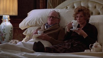 Movie still from “Being There” (1979), directed by Hal Ashby – An older man and woman sitting in a bed drinking coffee; Medium shot, High angle