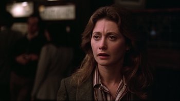 Movie still from “Being There” (1979), directed by Hal Ashby – A person wearing a suit and tie; Close Up shot, Over the shoulder angle