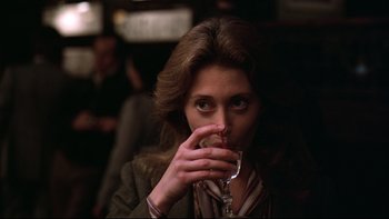 Movie still from “Being There” (1979), directed by Hal Ashby – A woman holding a wine glass in her hand; Close Up shot, Over the shoulder angle