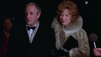 Movie still from “Being There” (1979), directed by Hal Ashby – An older man standing next to an older woman; Medium shot, Low angle
