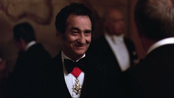 Movie still from “Being There” (1979), directed by Hal Ashby – A man in a suit and tie smiling for the camera; Close Up shot, Over the shoulder angle