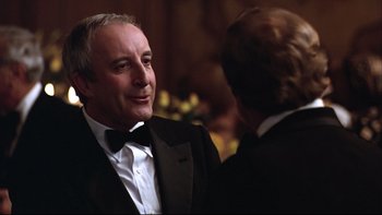 Movie still from “Being There” (1979), directed by Hal Ashby – A man in a tuxedo talking to another man in a suit; Close Up shot, Over the shoulder angle