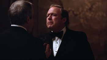 Movie still from “Being There” (1979), directed by Hal Ashby – A man in a tuxedo adjusting his bow tie; Close Up shot, Over the shoulder angle