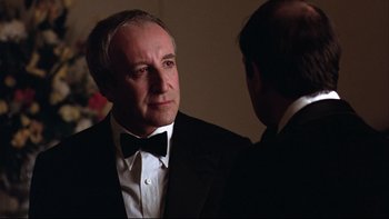 Movie still from “Being There” (1979), directed by Hal Ashby – A man in a suit and bow tie talking to another man in a suit and bow tie; Close Up shot, Over the shoulder angle