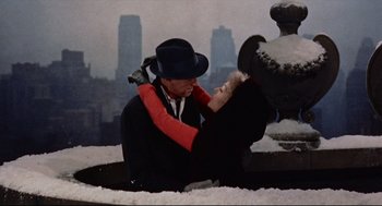 Movie still from “Bell, Book and Candle” (1976), directed by Hy Averback – A man and a woman are kissing in the snow; Medium shot, Overhead angle