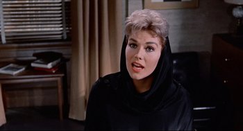 Movie still from “Bell, Book and Candle” (1976), directed by Hy Averback – A person wearing a black robe; Close Up shot, Over the shoulder angle