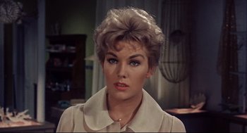 Movie still from “Bell, Book and Candle” (1976), directed by Hy Averback – A person with short hair wearing a dress; Close Up shot, High angle