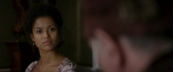 Movie still from “Belle” (2013), directed by Amma Asante – A woman is looking at the camera in the dark; Close Up shot, Over the shoulder angle