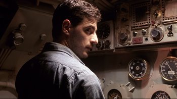 Movie still from “Below” (2002), directed by David Twohy – A person standing in a room; Close Up shot, Low angle