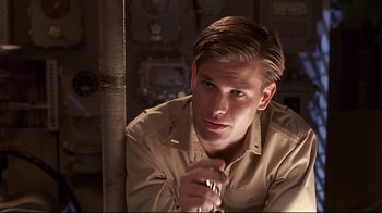 Movie still from “Below” (2002), directed by David Twohy – A man in a tan shirt is holding a pen; Close Up shot, Over the shoulder angle