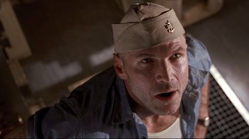 Movie still from “Below” (2002), directed by David Twohy – A person wearing a hat; Close Up shot, Low angle