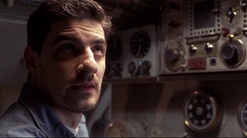 Movie still from “Below” (2002), directed by David Twohy – A person in a room with clocks; Close Up shot, Low angle