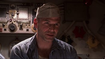 Movie still from “Below” (2002), directed by David Twohy – A person wearing a hat; Close Up shot, Low angle