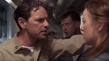 Movie still from “Below” (2002), directed by David Twohy – A group of people standing next to each other on a boat; Close Up shot, Over the shoulder angle
