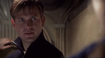 Movie still from “Below” (2002), directed by David Twohy – A person wearing a black jacket; Close Up shot, Over the shoulder angle