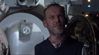 Movie still from “Below” (2002), directed by David Twohy – A person wearing a vest; Close Up shot, Low angle