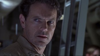 Movie still from “Below” (2002), directed by David Twohy – A person wearing a shirt; Close Up shot, Low angle