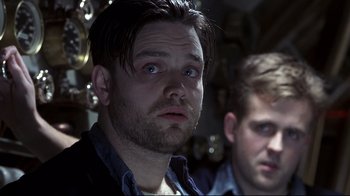 Movie still from “Below” (2002), directed by David Twohy – A man with blue eyes and a beard and another man with short hair; Close Up shot, Low angle