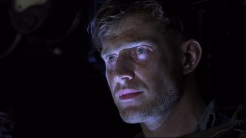 Movie still from “Below” (2002), directed by David Twohy – A person looking at the camera; Close Up shot, Low angle