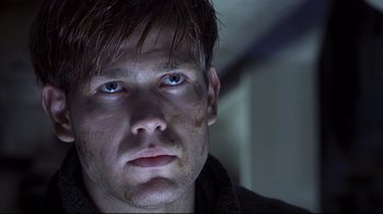 Movie still from “Below” (2002), directed by David Twohy – A person looking at the camera; Close Up shot, Low angle