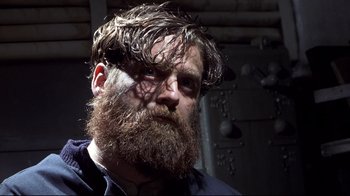Movie still from “Below” (2002), directed by David Twohy – A man with a long beard and a goatee; Close Up shot, Low angle