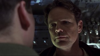 Movie still from “Below” (2002), directed by David Twohy – A person looking into a mirror; Close Up shot, Over the shoulder angle