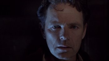 Movie still from “Below” (2002), directed by David Twohy – A person wearing a jacket; Close Up shot, Low angle