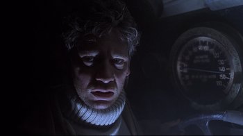 Movie still from “Below” (2002), directed by David Twohy – A person wearing a neck brace; Close Up shot, Low angle